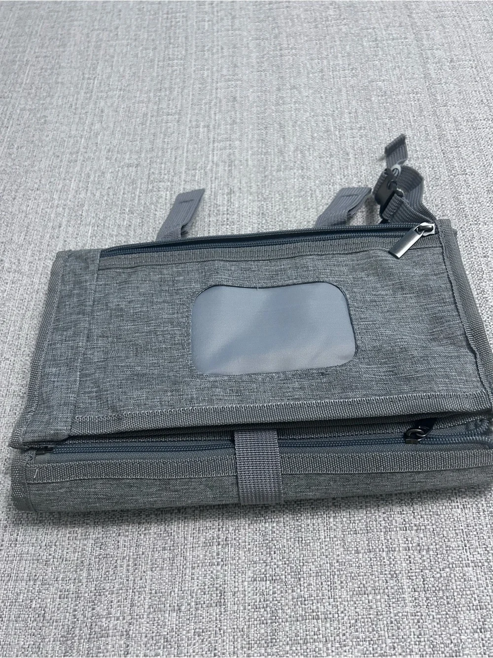 Grey Foldable Portable Changing Pad for Baby with Secure Buckle.